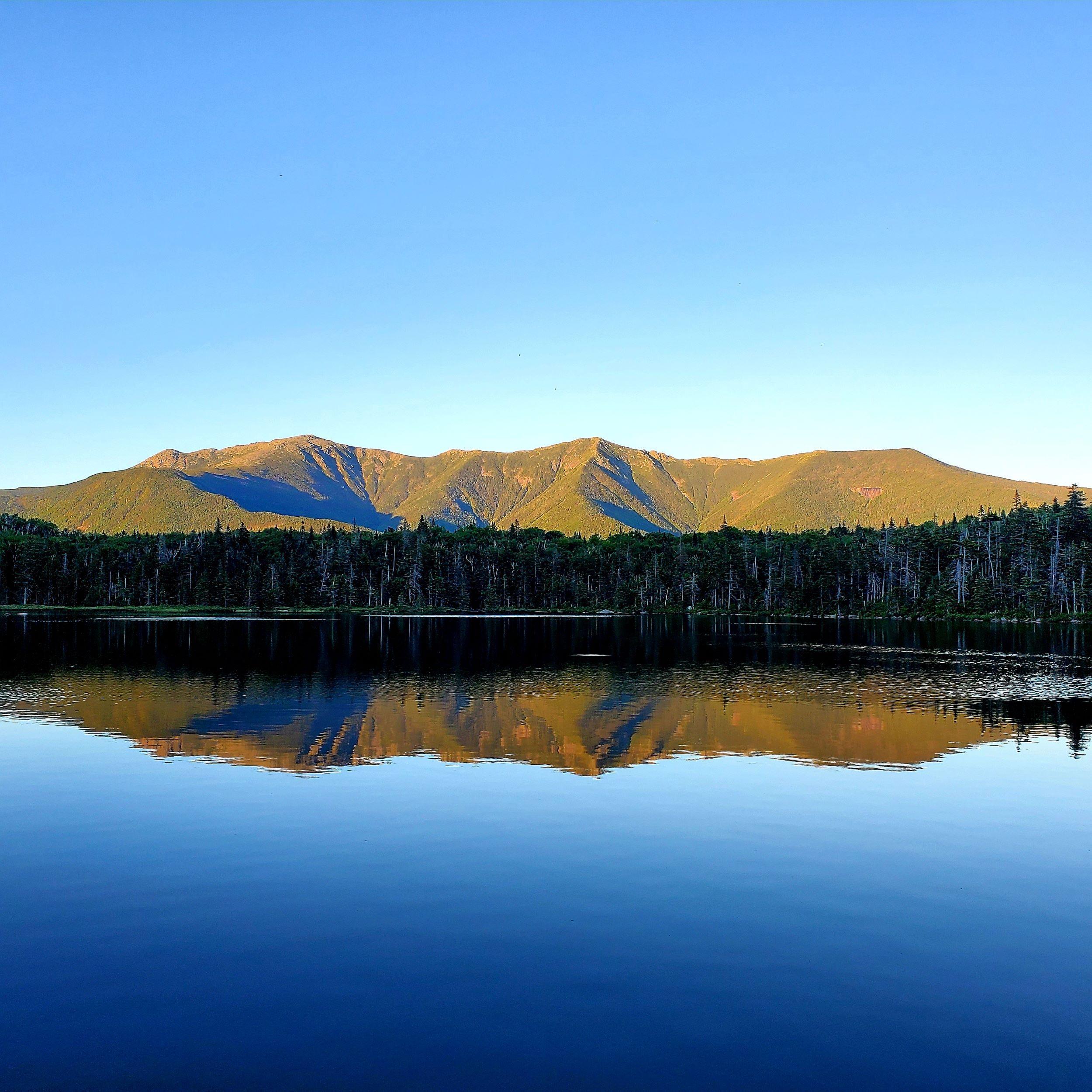 Glass lake with the Franconia Ridge perfectly reflected