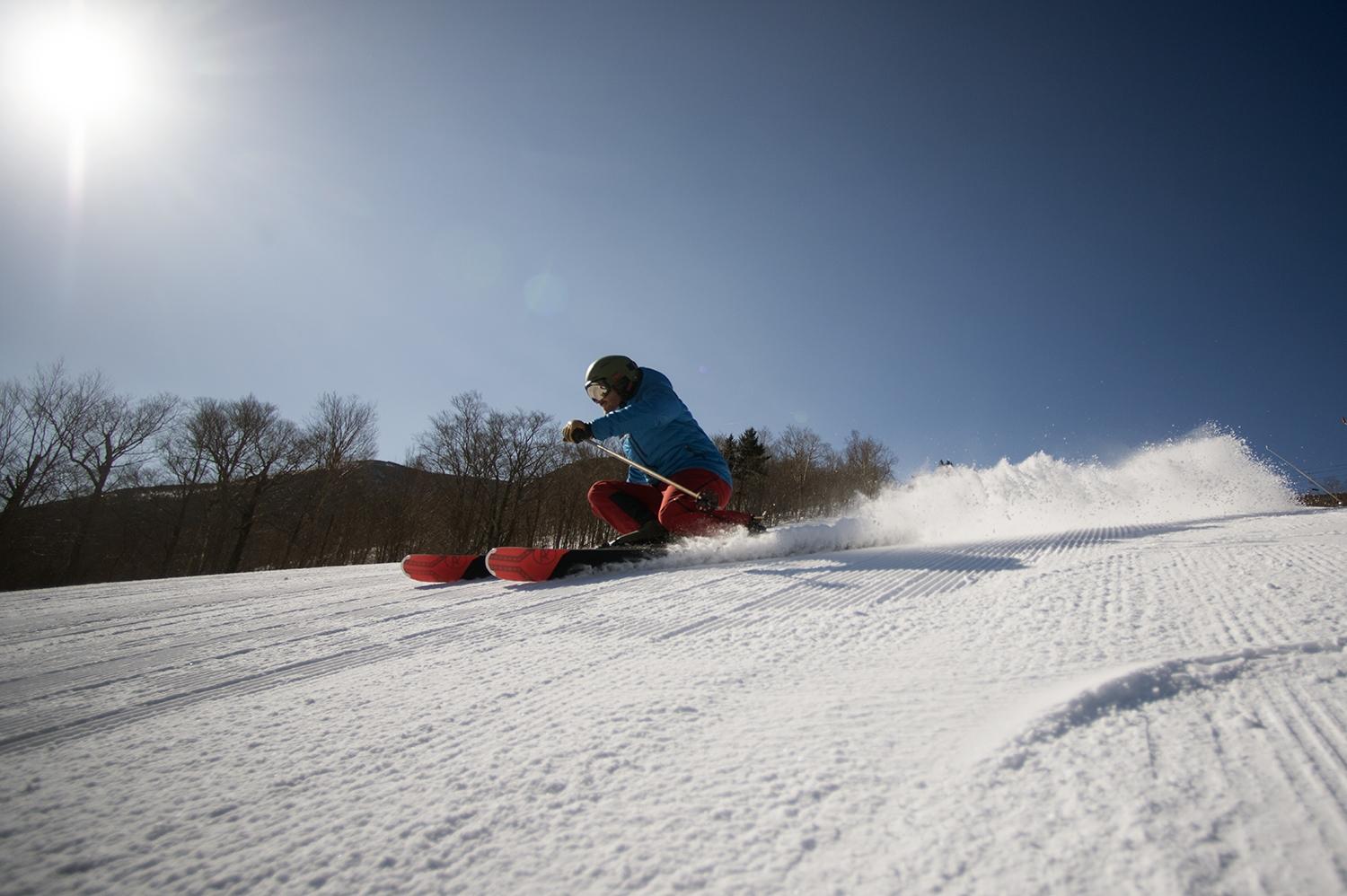 Skier making turns, sunny day