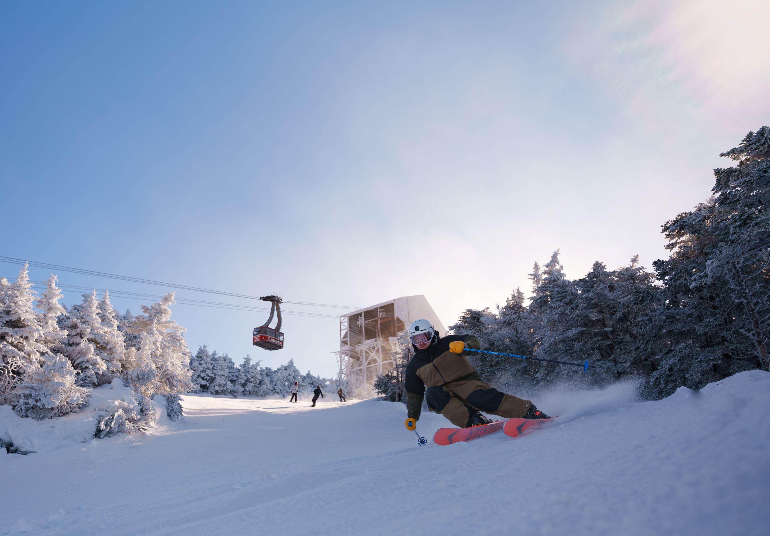 Skier on upper cannon with the tram in the background